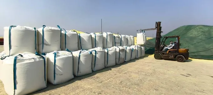 Forklift working alongside stacked jumbo bags